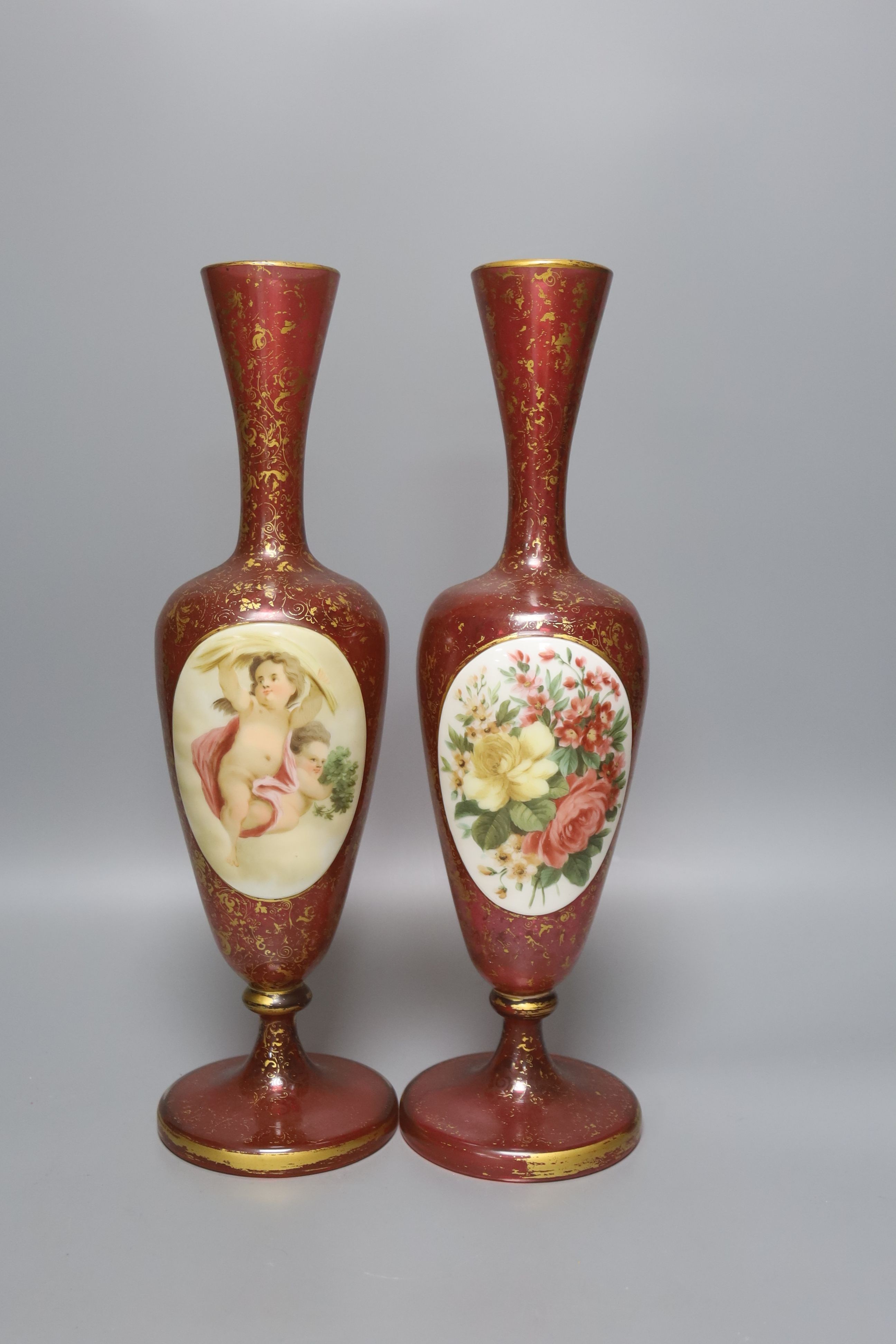A pair of 19th century Bohemian enamelled and overlaid ruby glass vases 36cm